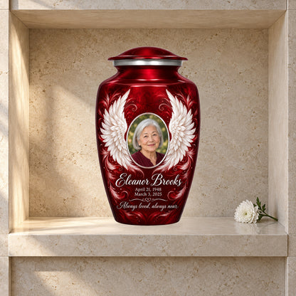 red adult urn with Crimson Uplifted Wings angel wings artwork displayed in a columbarium niche.