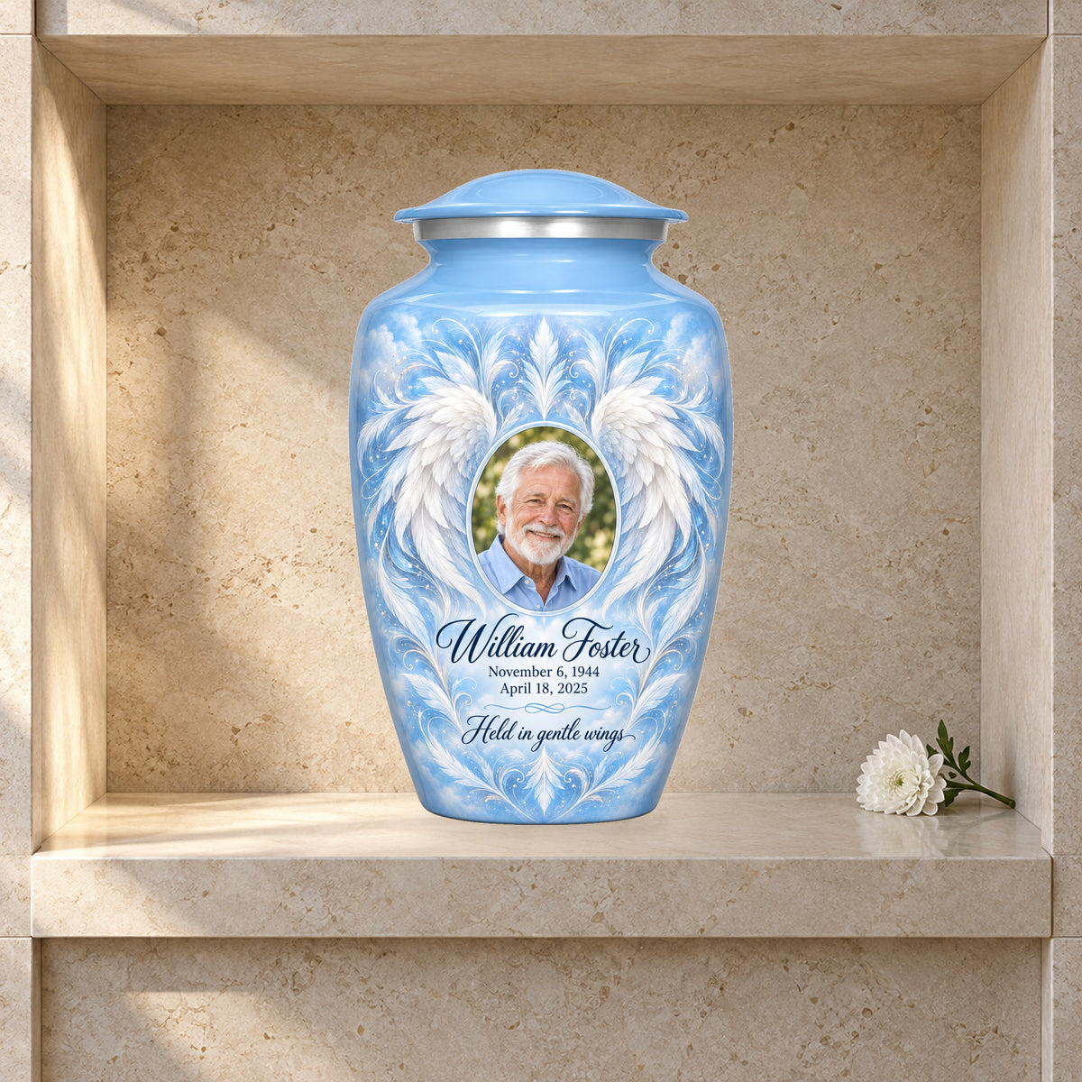 blue adult urn with Sky Feather Mandala angel wings artwork displayed in a columbarium niche.