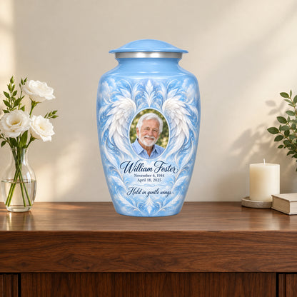 blue personalized angel wings adult urn on a memorial console.