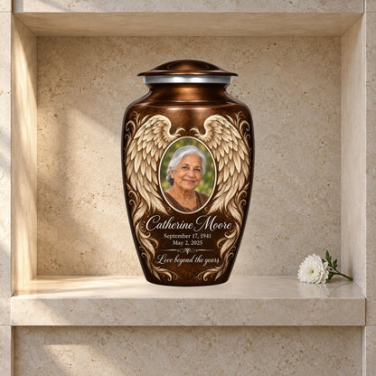 brown adult urn with Bronze Etched Wings angel wings artwork displayed in a columbarium niche.
