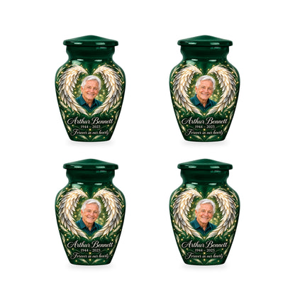 Four matching green angel wings keepsake urns with sample photo and inscription.