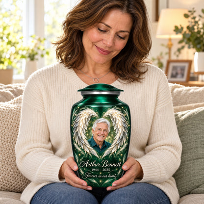 Seated person holding the green adult angel wings urn on their lap.