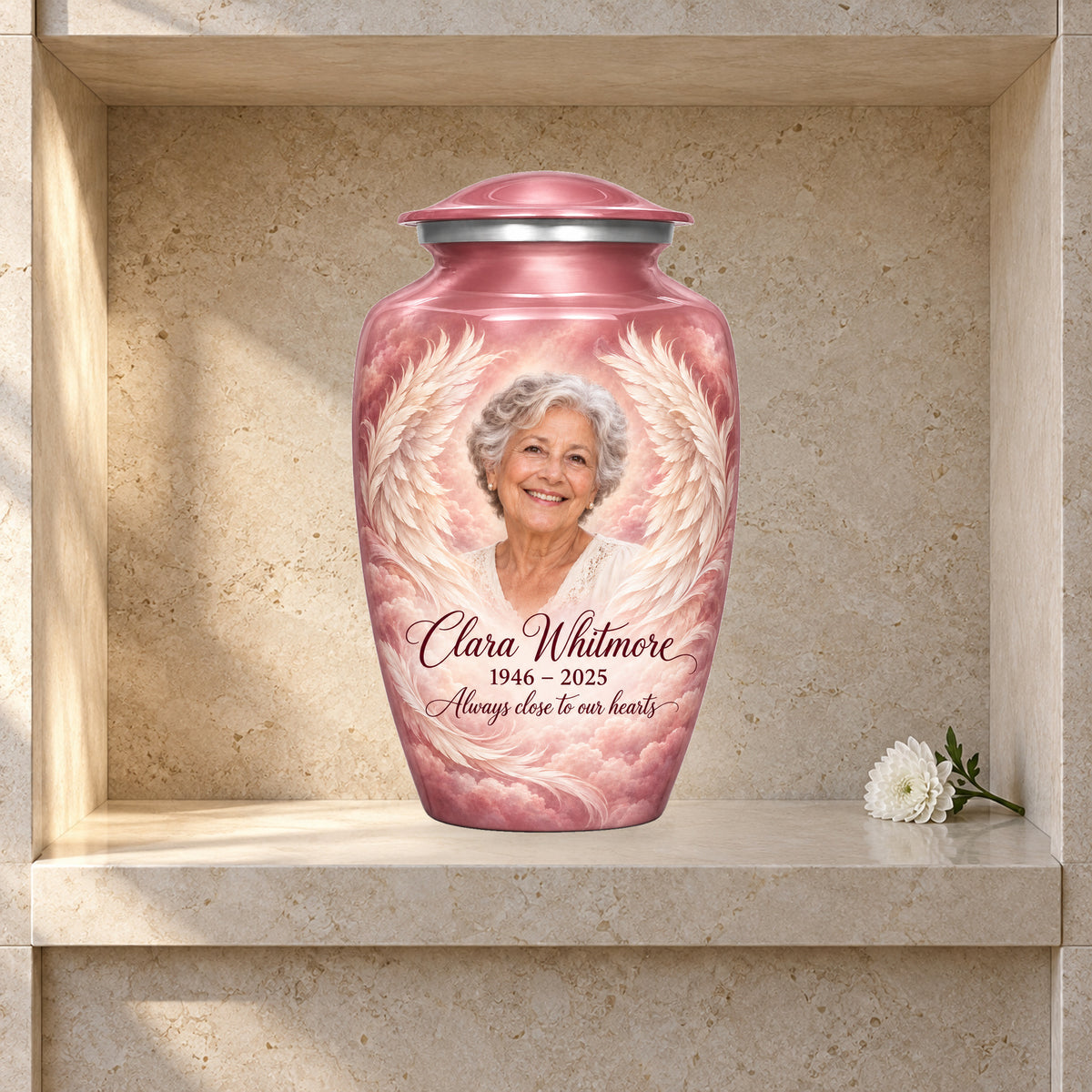 pink adult urn with Rose Cloud Wings angel wings artwork displayed in a columbarium niche.