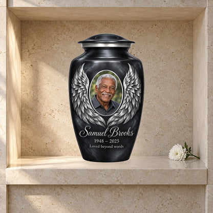 gray adult urn with Charcoal Silver Wings angel wings artwork displayed in a columbarium niche.