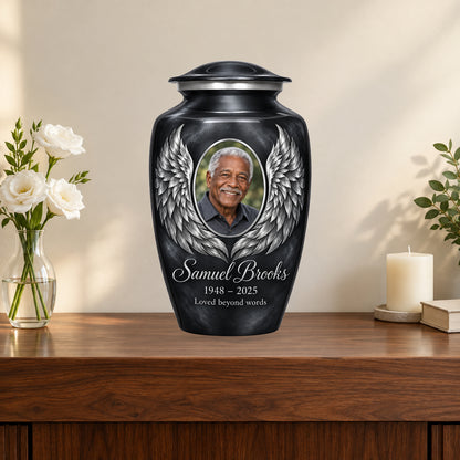 gray personalized angel wings adult urn on a memorial console.