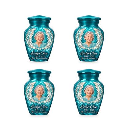 Four matching blue angel wings keepsake urns with sample photo and inscription.