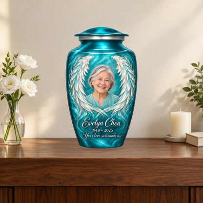 Blue personalized angel wings adult urn on a memorial console.