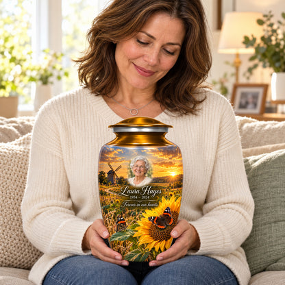 Seated person holding the adult Sunflower Mill butterfly urn on their lap.