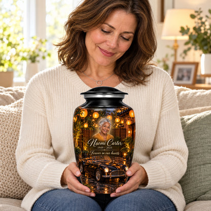 Seated person holding the adult Lantern Courtyard car urn on their lap.