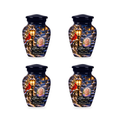 Four matching ringless Lantern Snow Courtyard cardinal keepsake urns with fictional sample personalization.