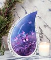 Large Butterfly urn with purple butterflies flying over a meadow design, ideal for adult female human ashes