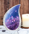 Large Butterfly urn with purple butterflies flying over a meadow design, ideal for adult female human ashes