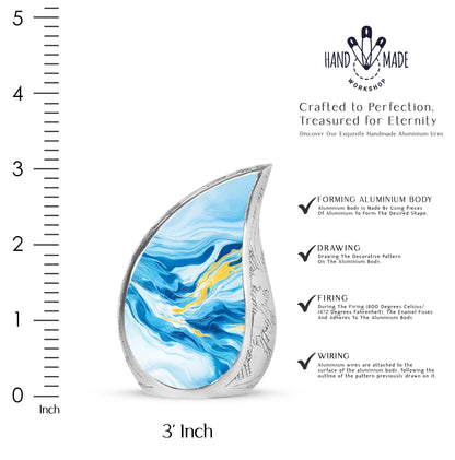 Dusty Blue Blue Cremation Urn angled view of lid and engraved motif - flowing teardrop blue silhouette on curved aluminum - mini keepsake memorial for portion of cremation ashes