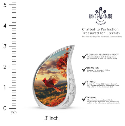 Matte Gold Cardinal Cremation Urn angled view of lid and engraved motif - graceful tear-shaped urn with cardinal motif - mini keepsake memorial for portion of cremation ashes