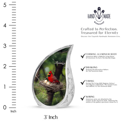 Hunter Green Cardinal Cremation Urn angled view of lid and engraved motif - graceful tear-shaped urn with cardinal motif - mini keepsake memorial for portion of cremation ashes