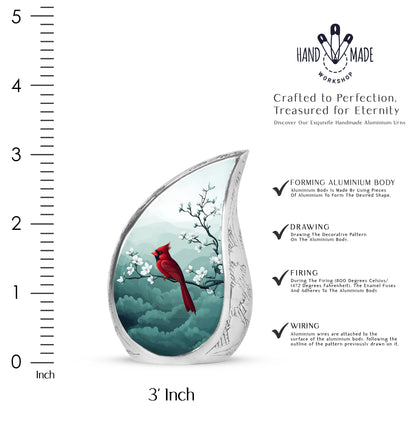 Platinum Silver Cardinal Cremation Urn angled view of lid and engraved motif - flowing teardrop cardinal silhouette on curved aluminum - mini keepsake memorial for portion of cremation ashes