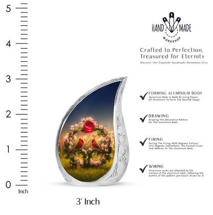 Cobalt Blue Cardinal Cremation Urn angled view of lid and engraved motif - graceful tear-shaped urn with cardinal motif - mini keepsake memorial for portion of cremation ashes
