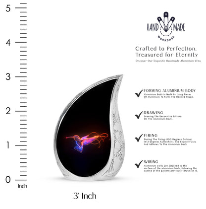Glossy Black Hummingbird Cremation Urn angled view of lid and engraved motif - flowing teardrop hummingbird silhouette on curved aluminum - mini keepsake memorial for portion of cremation ashes