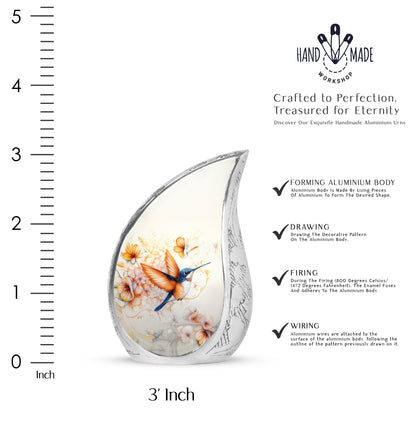 Charcoal Gray Hummingbird Cremation Urn angled view of lid and engraved motif - flowing teardrop hummingbird silhouette on curved aluminum - mini keepsake memorial for portion of cremation ashes