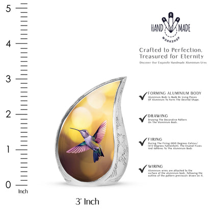 Antique Gold Hummingbird Cremation Urn angled view of lid and engraved motif - rounded teardrop hummingbird design with delicate detail - mini keepsake memorial for portion of cremation ashes