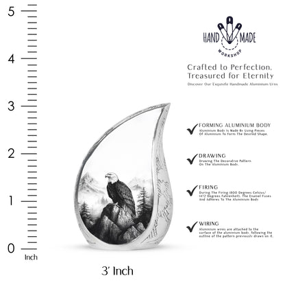 Gleaming Silver Eagle Cremation Urn angled view of lid and engraved motif - flowing teardrop eagle silhouette on curved aluminum - mini keepsake memorial for portion of cremation ashes