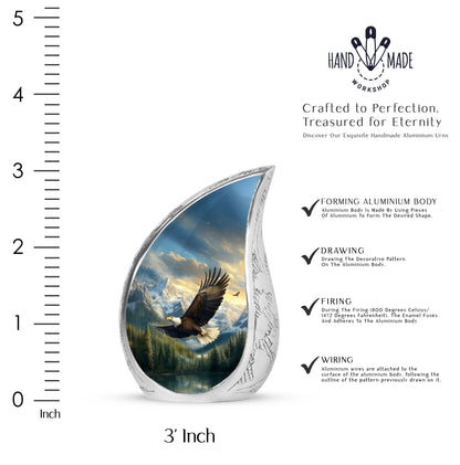 Misty Blue Eagle Cremation Urn angled view of lid and engraved motif - flowing teardrop eagle silhouette on curved aluminum - mini keepsake memorial for portion of cremation ashes