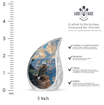 Navy Blue Eagle Cremation Urn angled view of lid and engraved motif - flowing teardrop eagle silhouette on curved aluminum - mini keepsake memorial for portion of cremation ashes