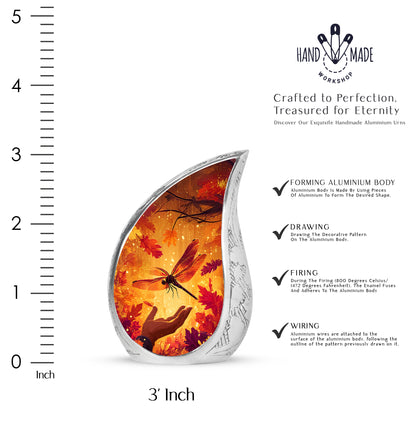 Antique Gold Dragonfly Cremation Urn angled view of lid and engraved motif - flowing teardrop dragonfly silhouette on curved aluminum - mini keepsake memorial for portion of cremation ashes