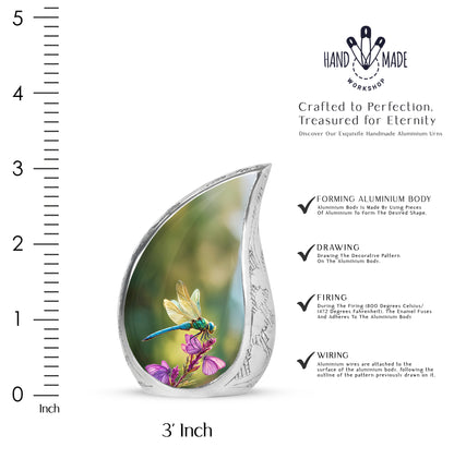 Sage Green Dragonfly Cremation Urn angled view of lid and engraved motif - flowing teardrop dragonfly silhouette on curved aluminum - mini keepsake memorial for portion of cremation ashes