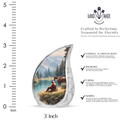 Dusty Blue Cowboy Cremation Urn angled view of lid and engraved motif - flowing teardrop cowboy silhouette on curved aluminum - mini keepsake memorial for portion of cremation ashes