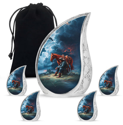 Pastel Blue Cowboy Cremation Urn side profile showing urn shape - flowing teardrop cowboy silhouette on curved aluminum - memorial set with one large and four small urns