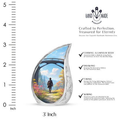 Indigo Cowboy Cremation Urn angled view of lid and engraved motif - flowing teardrop cowboy silhouette on curved aluminum - mini keepsake memorial for portion of cremation ashes