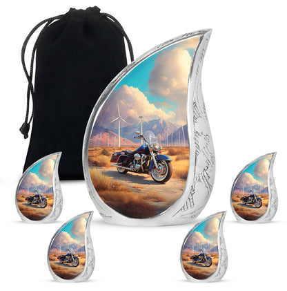 Burnished Gold Bike Cremation Urn side profile showing urn shape - graceful tear-shaped urn with bike motif - memorial set with one large and four small urns