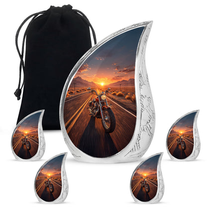Champagne Gold Bike Cremation Urn side profile showing urn shape - flowing teardrop bike silhouette on curved aluminum - memorial set with one large and four small urns