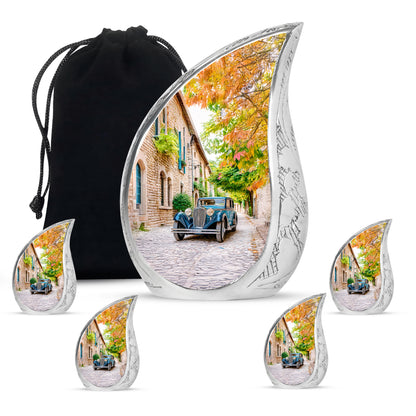 Champagne Gold Car Cremation Urn side profile showing urn shape - rounded teardrop car design with delicate detail - memorial set with one large and four small urns