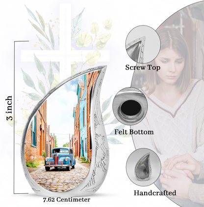 Gleaming Silver Car Cremation Urn angled view of lid and engraved motif - rounded teardrop car design with delicate detail - mini keepsake memorial for portion of cremation ashes