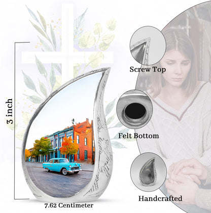 Chrome Silver Car Cremation Urn angled view of lid and engraved motif - graceful tear-shaped urn with car motif - mini keepsake memorial for portion of cremation ashes