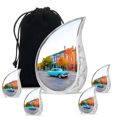 Brushed Silver Car Cremation Urn side profile showing urn shape - flowing teardrop car silhouette on curved aluminum - memorial set with one large and four small urns