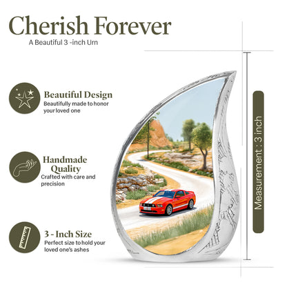 Antique Gold Car Cremation Urn angled view of lid and engraved motif - flowing teardrop car silhouette on curved aluminum - mini keepsake memorial for portion of cremation ashes