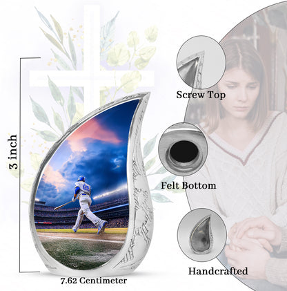 Icy Blue Baseball Cremation Urn angled view of lid and engraved motif - flowing teardrop baseball silhouette on curved aluminum - mini keepsake memorial for portion of cremation ashes