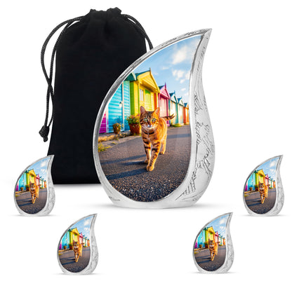Jewel Teal Cat Cremation Urn side profile showing urn shape - flowing teardrop cat silhouette on curved aluminum - memorial set with one large and four small urns
