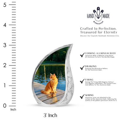 Sage Green Cat Cremation Urn angled view of lid and engraved motif - flowing teardrop cat silhouette on curved aluminum - mini keepsake memorial for portion of cremation ashes