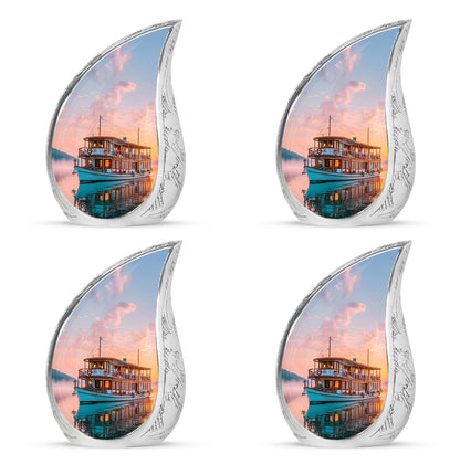 Ruby Red Boat Cremation Urn close-up of engraving and surface detail - graceful tear-shaped urn with boat motif - 10 inch aluminum urn for cremated remains