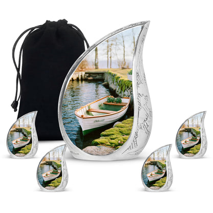 Soft Yellow Boat Cremation Urn side profile showing urn shape - graceful tear-shaped urn with boat motif - memorial set with one large and four small urns