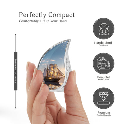 Royal Blue Boat Cremation Urn angled view of lid and engraved motif - smooth teardrop contour featuring boat art - mini keepsake memorial for portion of cremation ashes