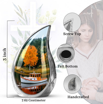 Moss Green Boat Cremation Urn angled view of lid and engraved motif - flowing teardrop boat silhouette on curved aluminum - mini keepsake memorial for portion of cremation ashes