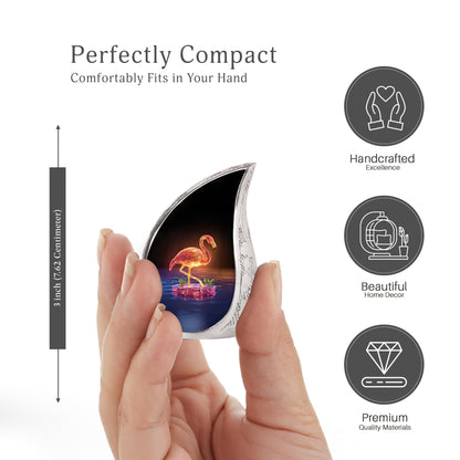 Deep Black Flamingo Cremation Urn angled view of lid and engraved motif - flowing teardrop flamingo silhouette on curved aluminum - mini keepsake memorial for portion of cremation ashes