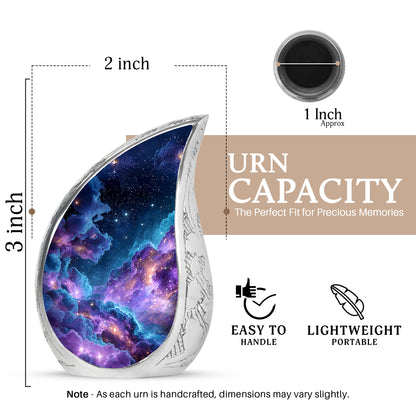 Icy Blue Galaxy Cremation Urn angled view of lid and engraved motif - rounded teardrop galaxy design with delicate detail - mini keepsake memorial for portion of cremation ashes