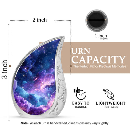 Dusty Blue Galaxy Cremation Urn angled view of lid and engraved motif - flowing teardrop galaxy silhouette on curved aluminum - mini keepsake memorial for portion of cremation ashes