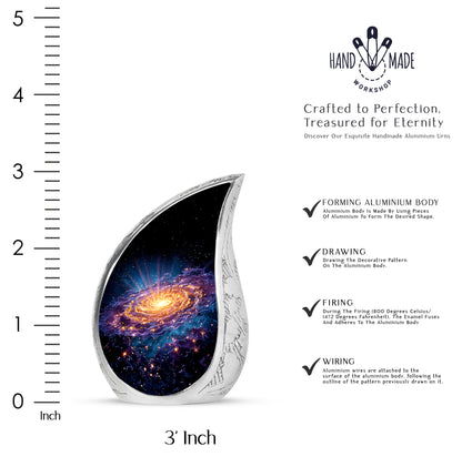 Deep Black Galaxy Cremation Urn angled view of lid and engraved motif - flowing teardrop galaxy silhouette on curved aluminum - mini keepsake memorial for portion of cremation ashes